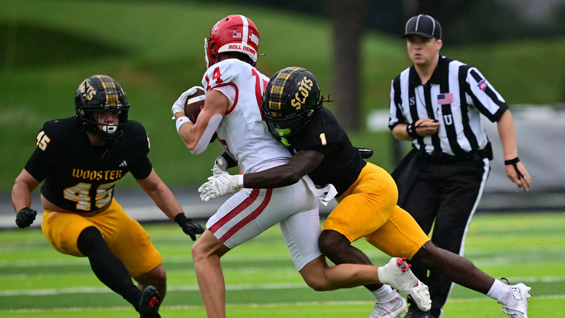 College football player carrying the ball during a tackle in a game