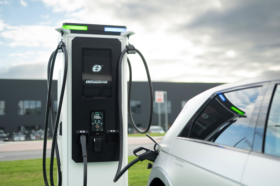 Electric vehicle plugged into a modern EV fast-charging station