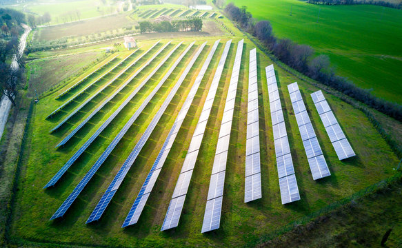 Aerial view of a large solar panel farm in green American farmland