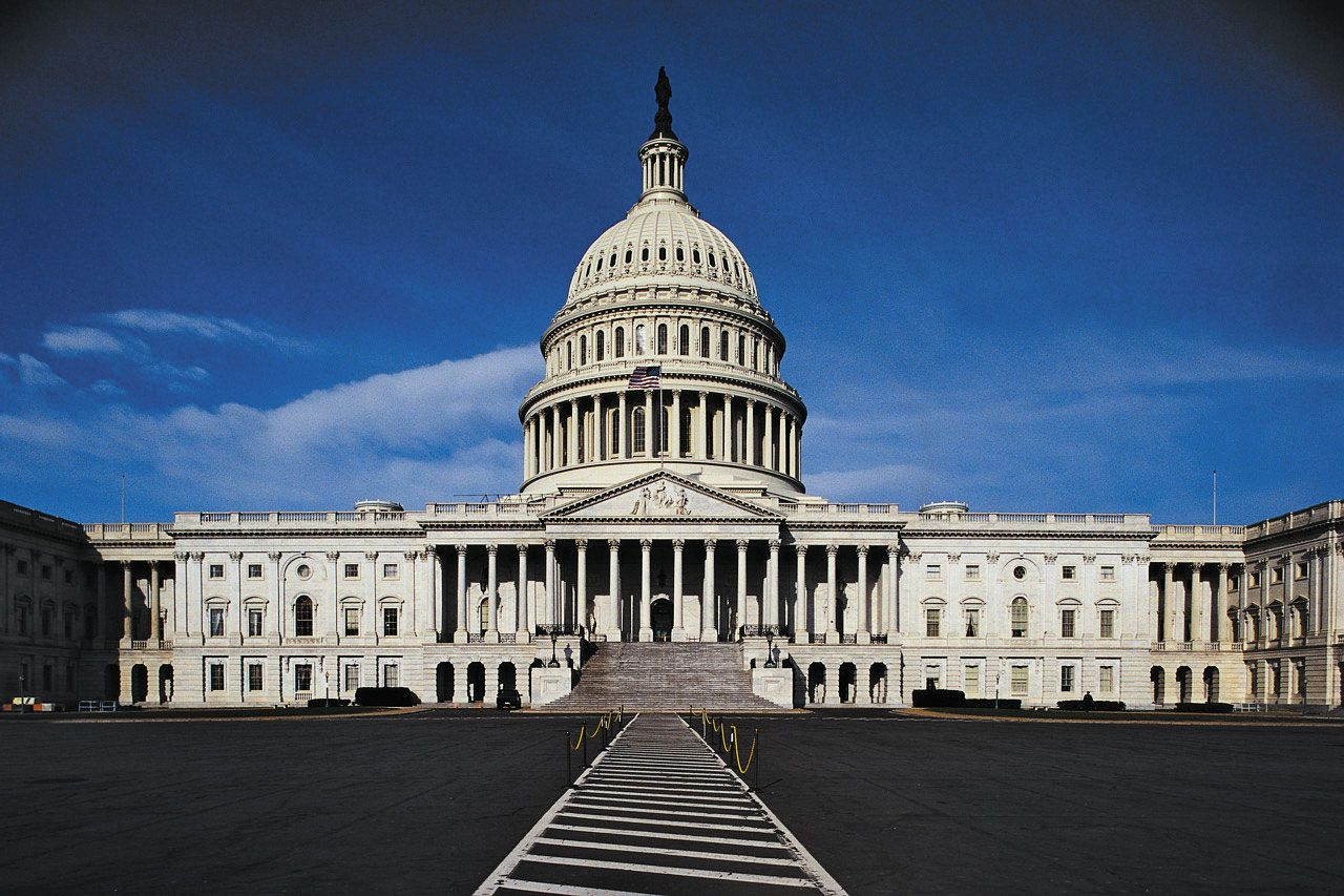 United States Capitol building in Washington DC against a deep blue sky
